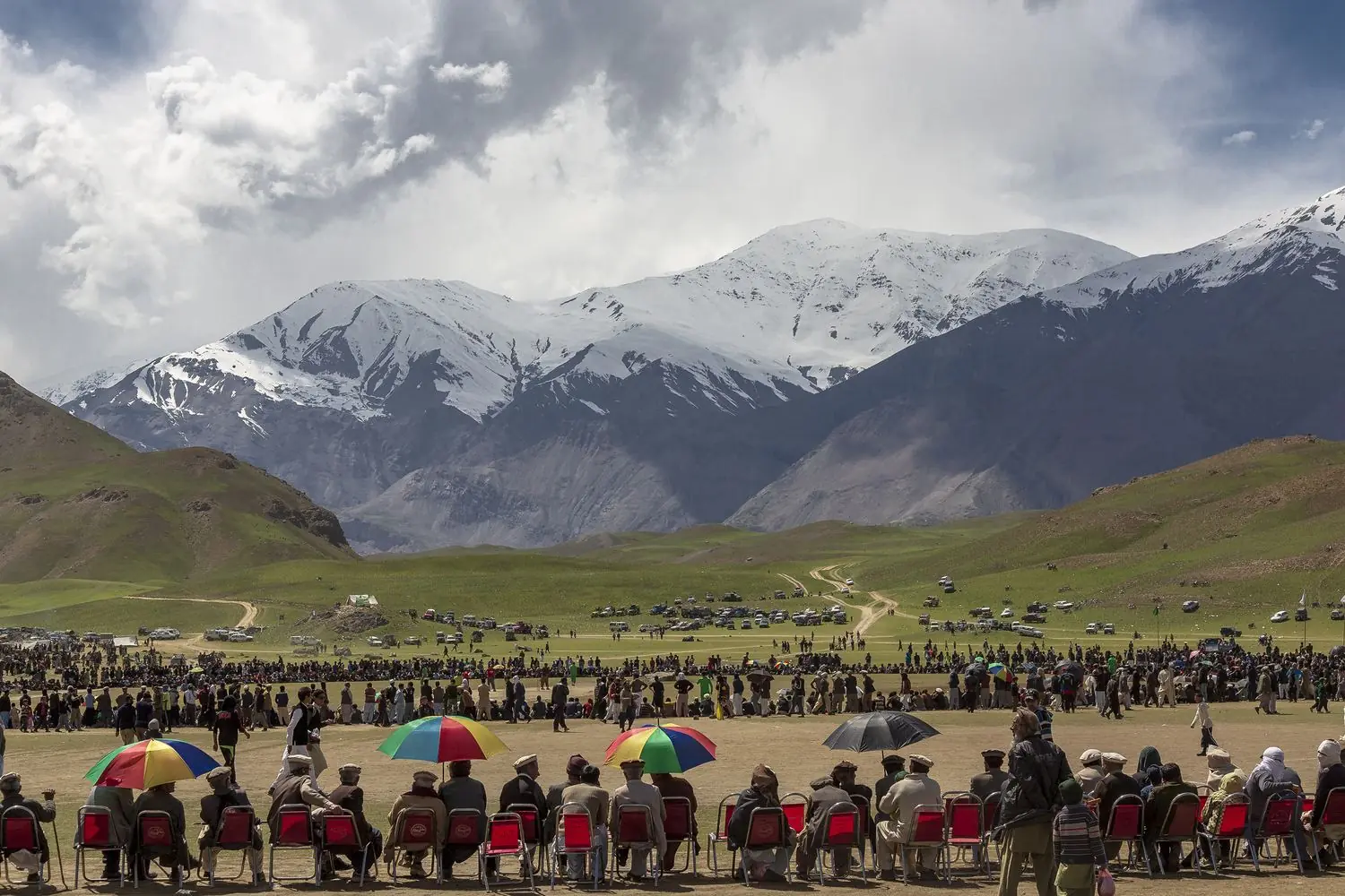 Crowds at the Qaqlasht spring festival below snow-streaked peaks