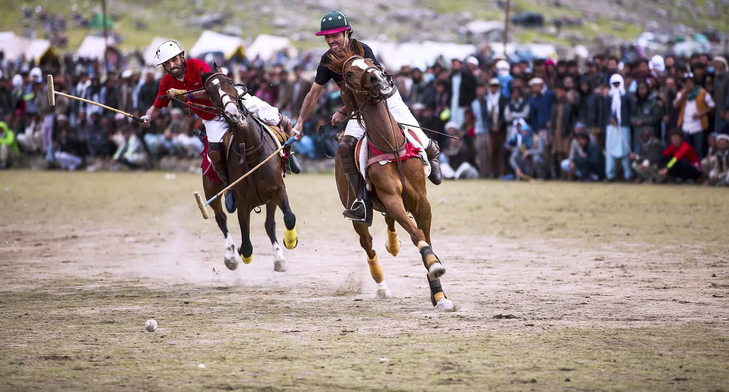Polo players at full gallop on the Shandur ground