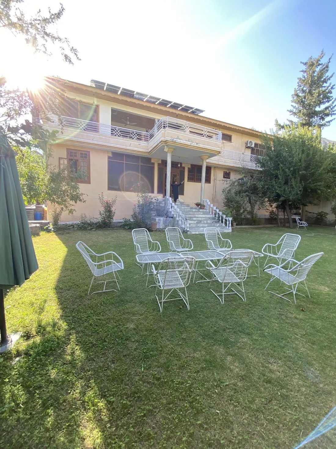 Garden chairs set out on the lawn in front of the guesthouse