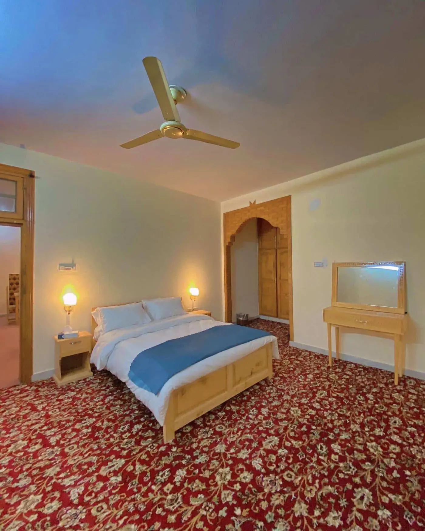 Master bedroom with double bed, dressing table and hand-woven carpet